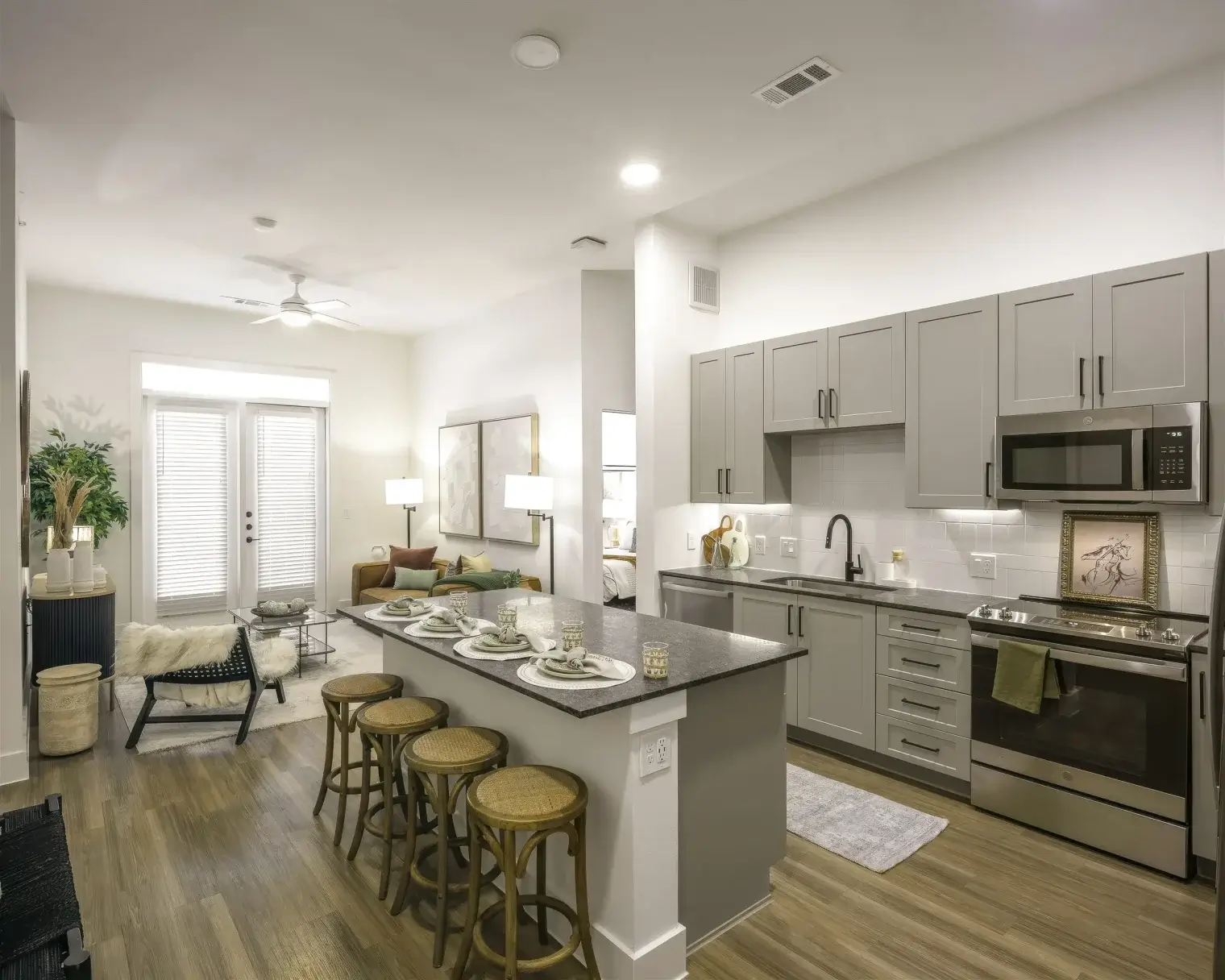 Open apartment kitchen and living area with breakfast bar seating at Parker at Walsh in Aledo