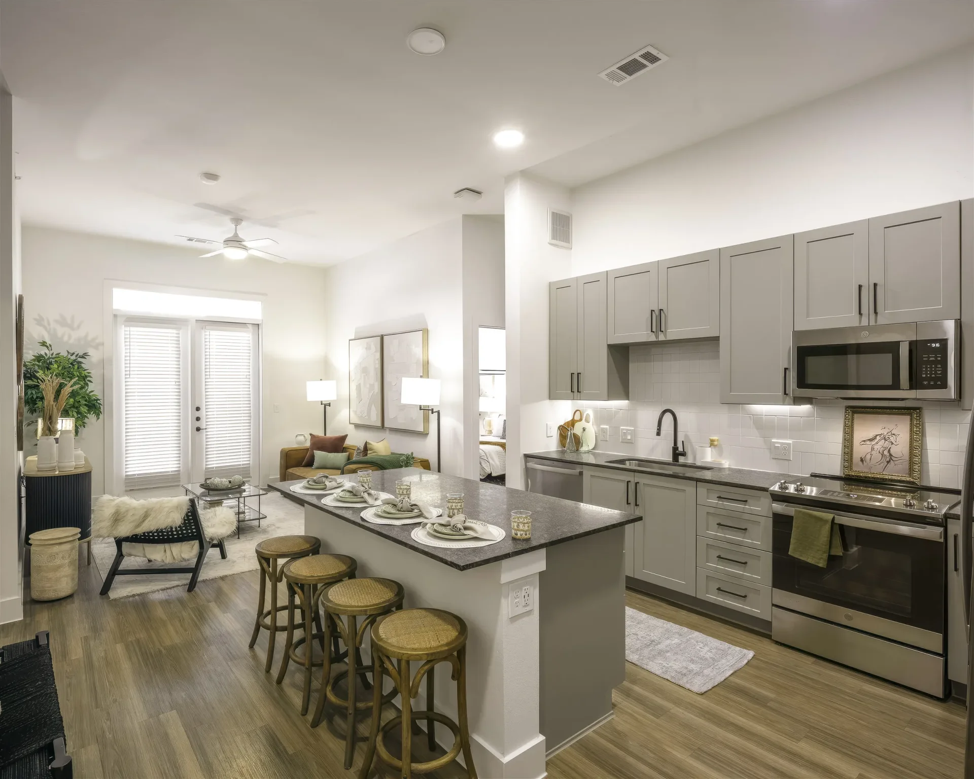 Open apartment kitchen and living area with breakfast bar seating at Parker at Walsh in Aledo