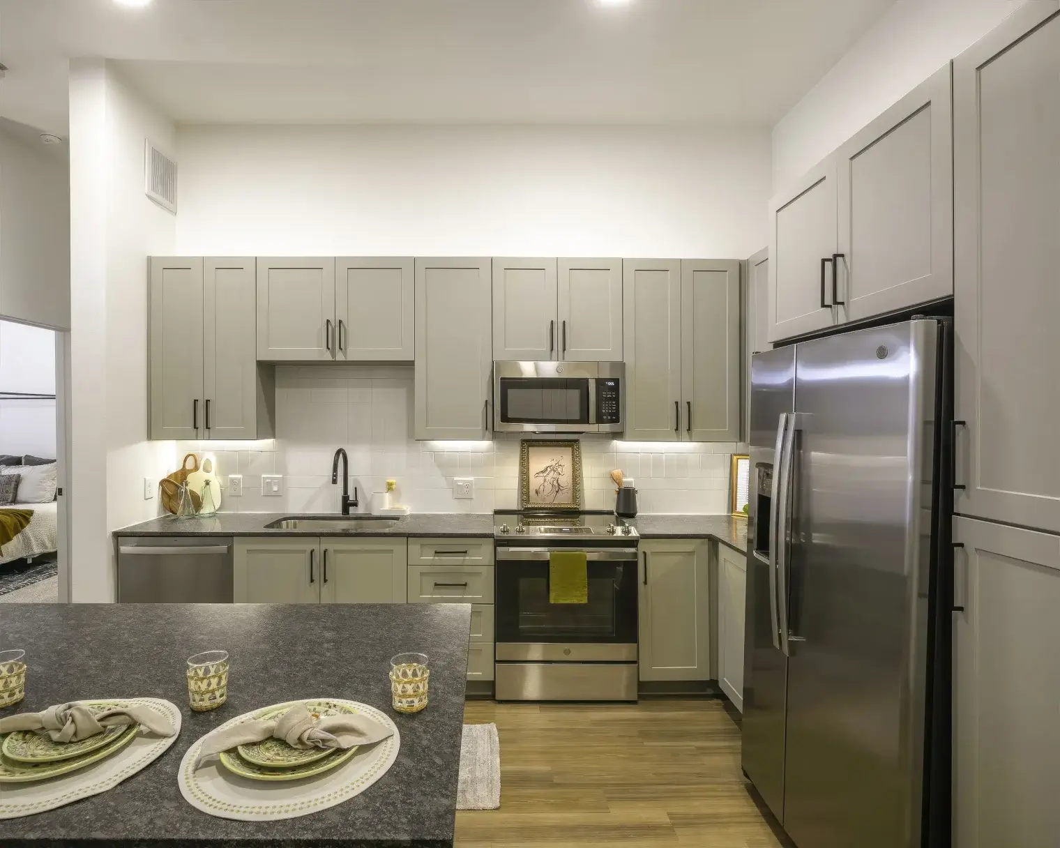 Gourmet kitchen with stainless steel appliances and granite breakfast bar at Parker at Walsh