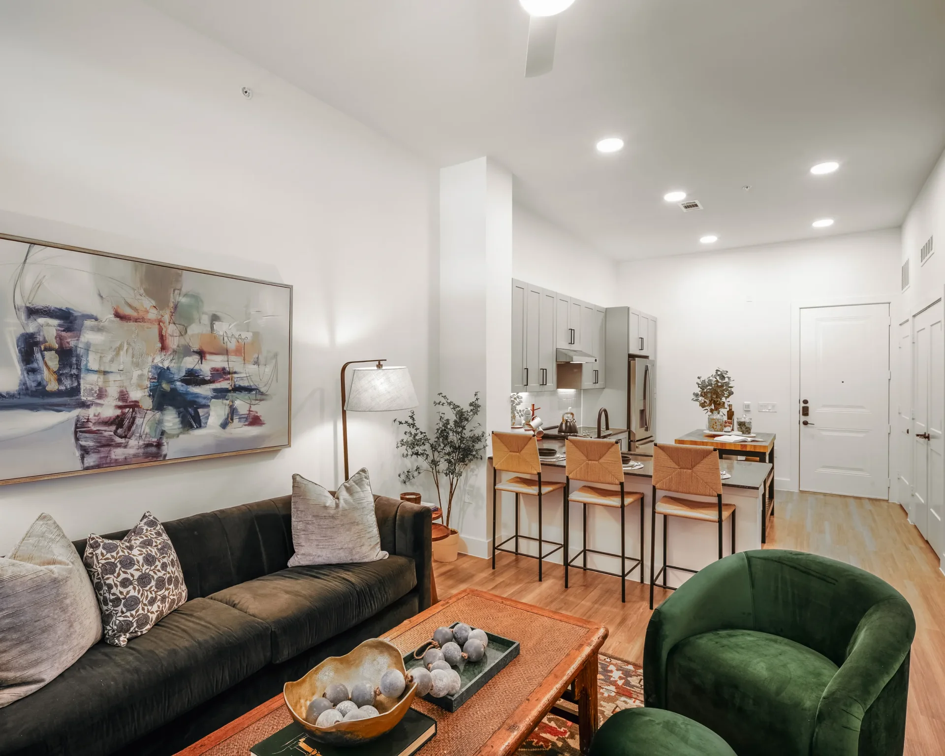 Open-concept apartment living room and kitchen at Parker at Walsh in Aledo, Texas